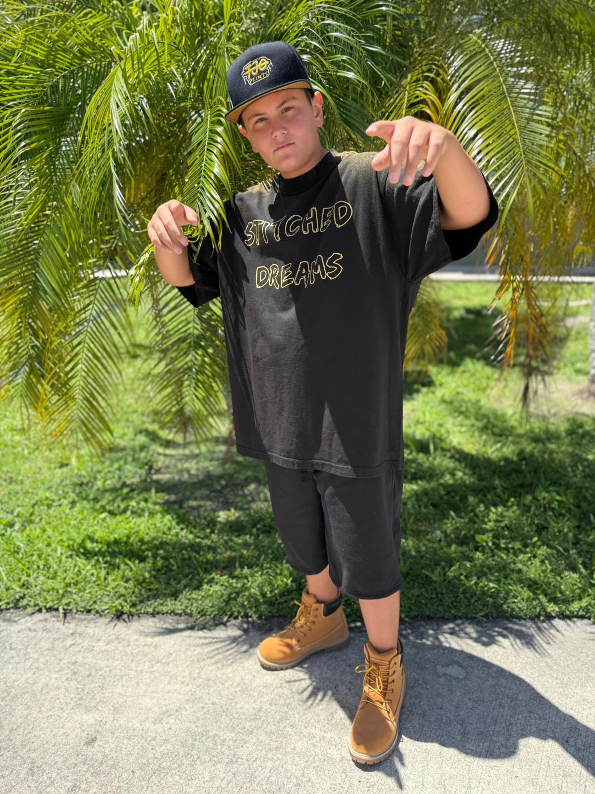Young creator in a Stitched Dreams tee and FJO cap